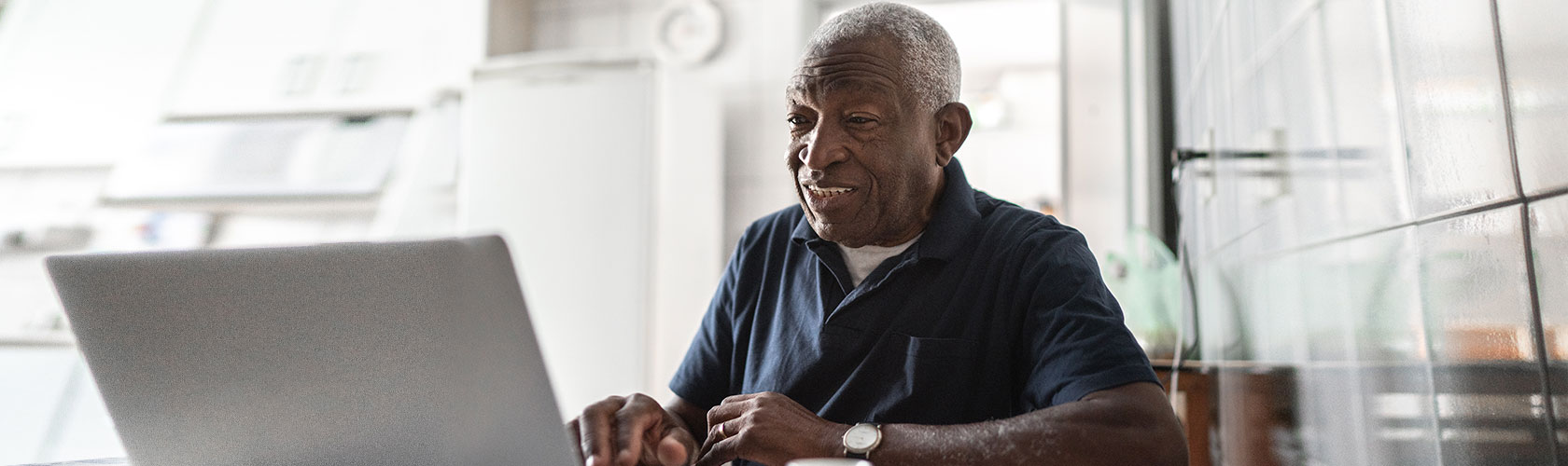 senior citizen using laptop computer